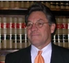 Attorney Charles D. Esquibel in front of a shelf of law books
